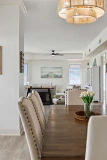 a kitchen with granite countertop a stove a sink and a refrigerator with wooden cabinets