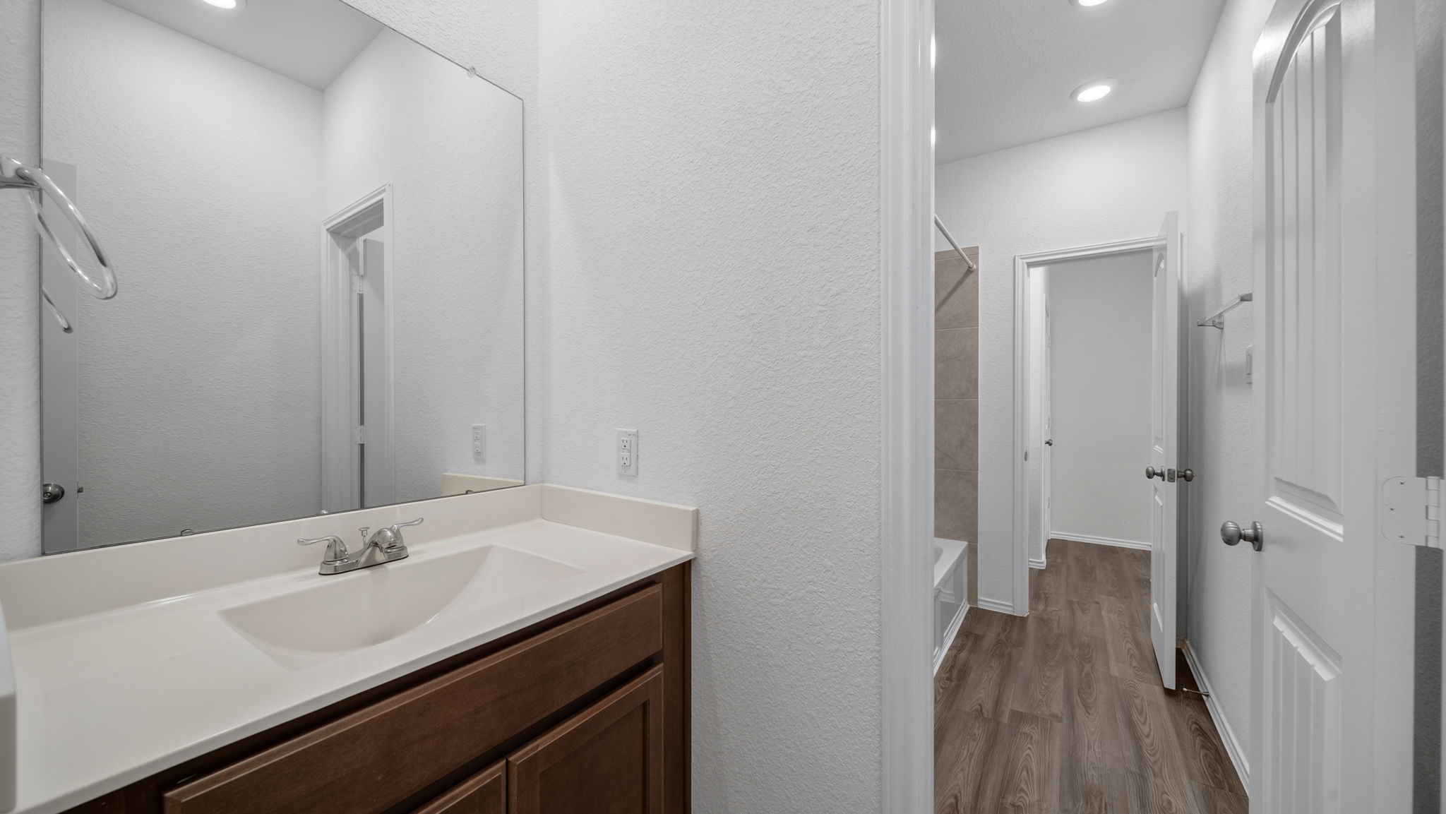 12348 Delta Timber Road Conroe, TX 77304 - Photo 16 of 22 The well-appointed secondary bathroom features a spacious vanity with ample counter space, generous storage, and a convenient layout designed for busy mornings.
