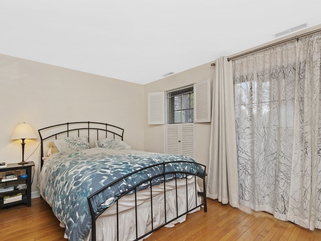 100 Main Street, Unit 2 Boston, MA 02129 - Photo 12 of 18 a bedroom with a bed and a mirror