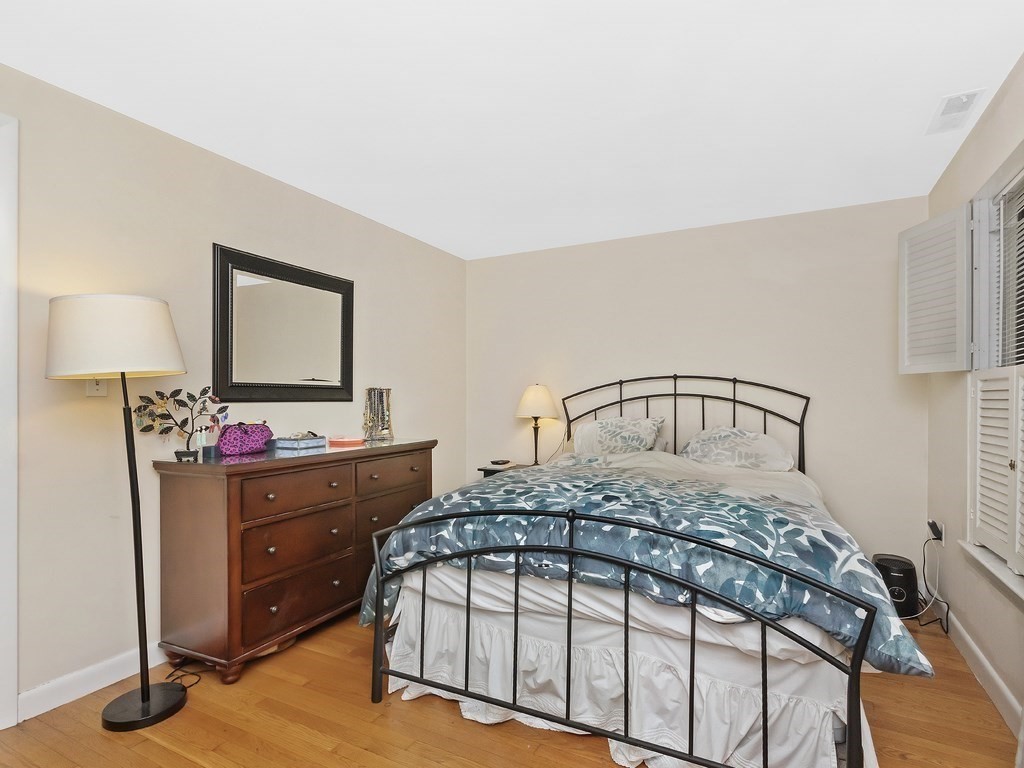 100 Main Street, Unit 2 Boston, MA 02129 - Photo 13 of 18 a bedroom with a bed and a dresser in it