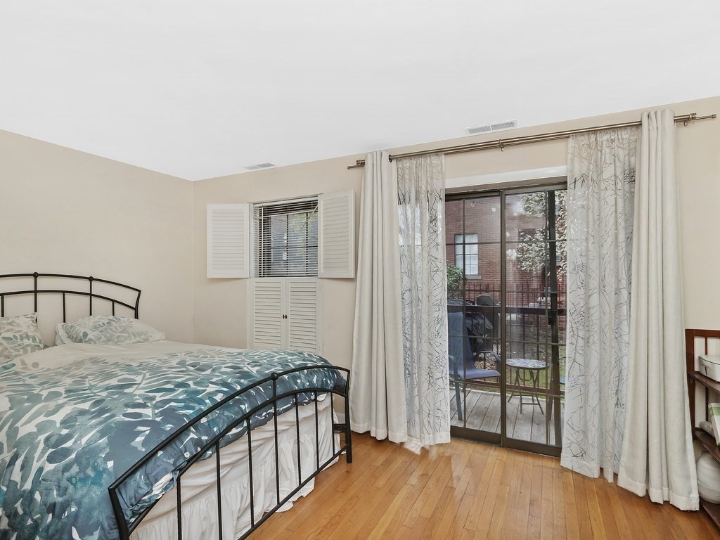 100 Main Street, Unit 2 Boston, MA 02129 - Photo 14 of 18 a bedroom with a bed and a window