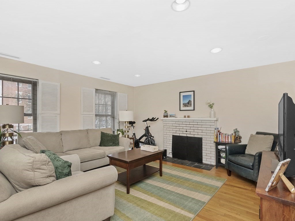 100 Main Street, Unit 2 Boston, MA 02129 - Photo 3 of 18 a living room with furniture flat screen tv and a fireplace