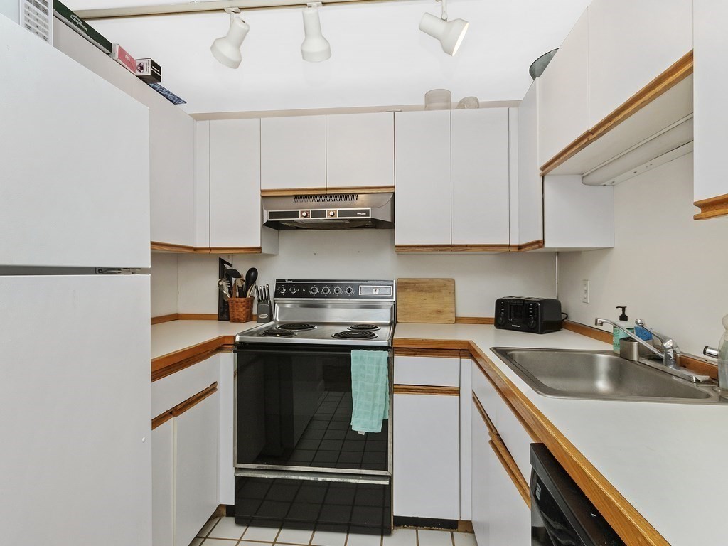 100 Main Street, Unit 2 Boston, MA 02129 - Photo 8 of 18 a kitchen with stainless steel appliances granite countertop a sink and cabinets