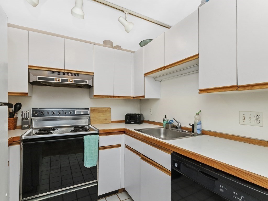 100 Main Street, Unit 2 Boston, MA 02129 - Photo 9 of 18 a kitchen with stainless steel appliances a stove a sink and cabinets