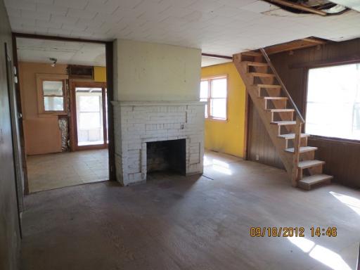 16080 Pratt Road Sandwich, IL 60548 - Photo 4 of 13 a view of a livingroom with an empty space and a fireplace