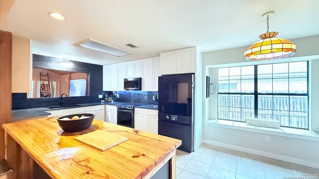 a kitchen with a stove a refrigerator and a sink