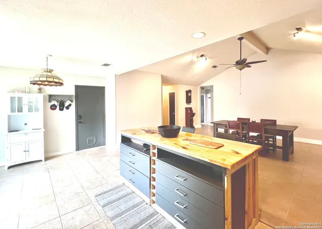 a room with a sink and chandelier