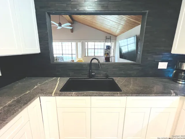 a kitchen with a sink and a window