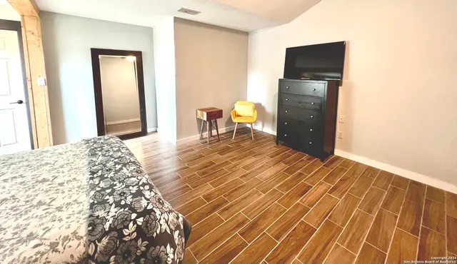 a bedroom with a bed and a television