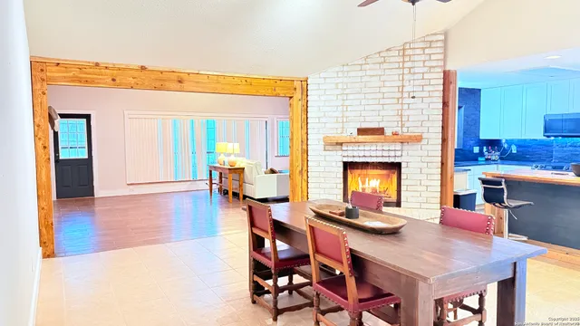 a view of a dining room with furniture and a fireplace