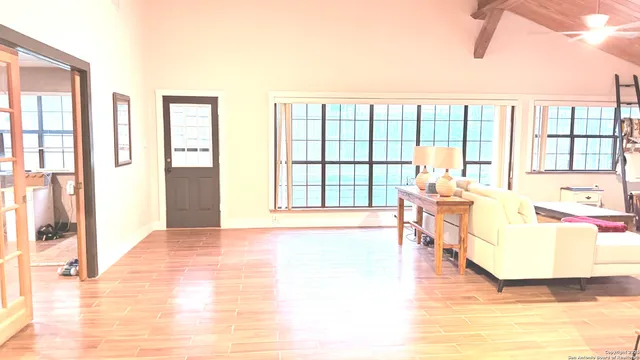 a living room with furniture and a large window