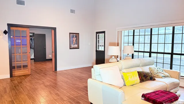 a living room with furniture and wooden floor
