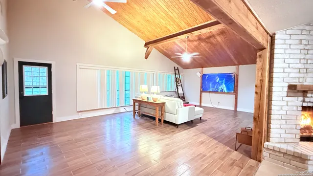 a spacious bedroom with a bed and wooden floor