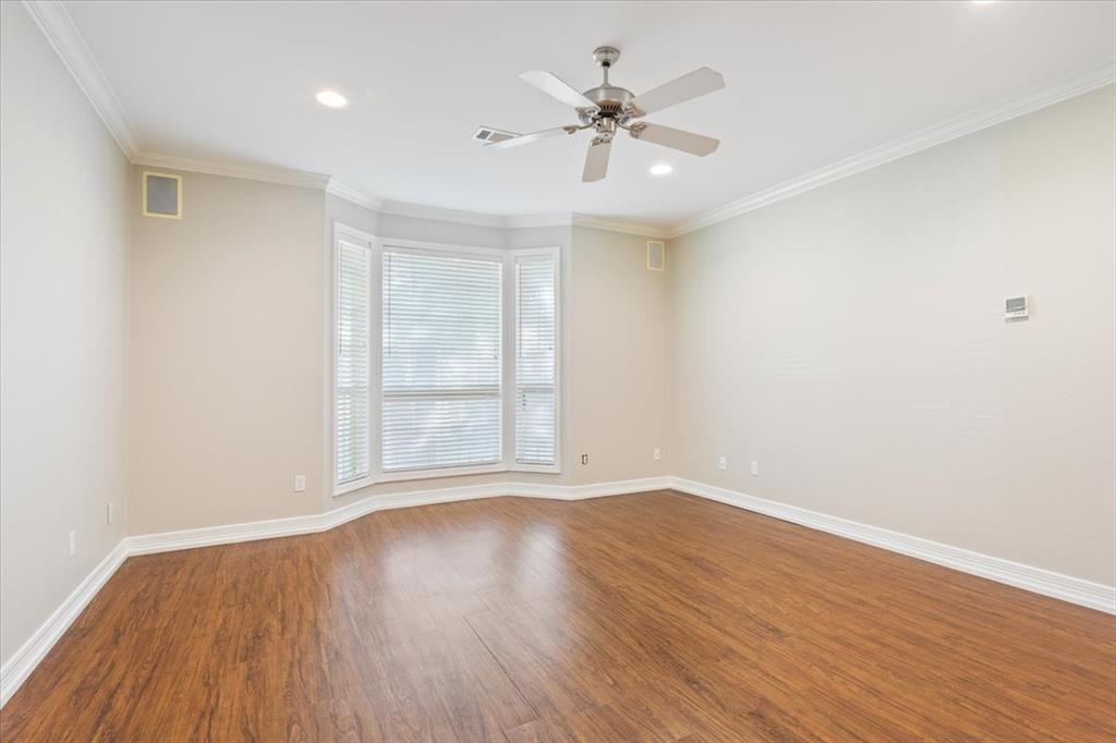 9412 Silverthorn Drive Waco, TX 76708 - Photo 11 of 16 a view of an empty room with wooden floor and a window