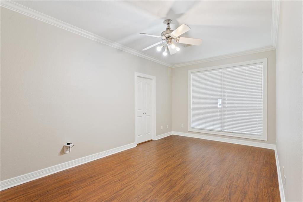 9412 Silverthorn Drive Waco, TX 76708 - Photo 12 of 16 a view of an empty room with wooden floor and a window