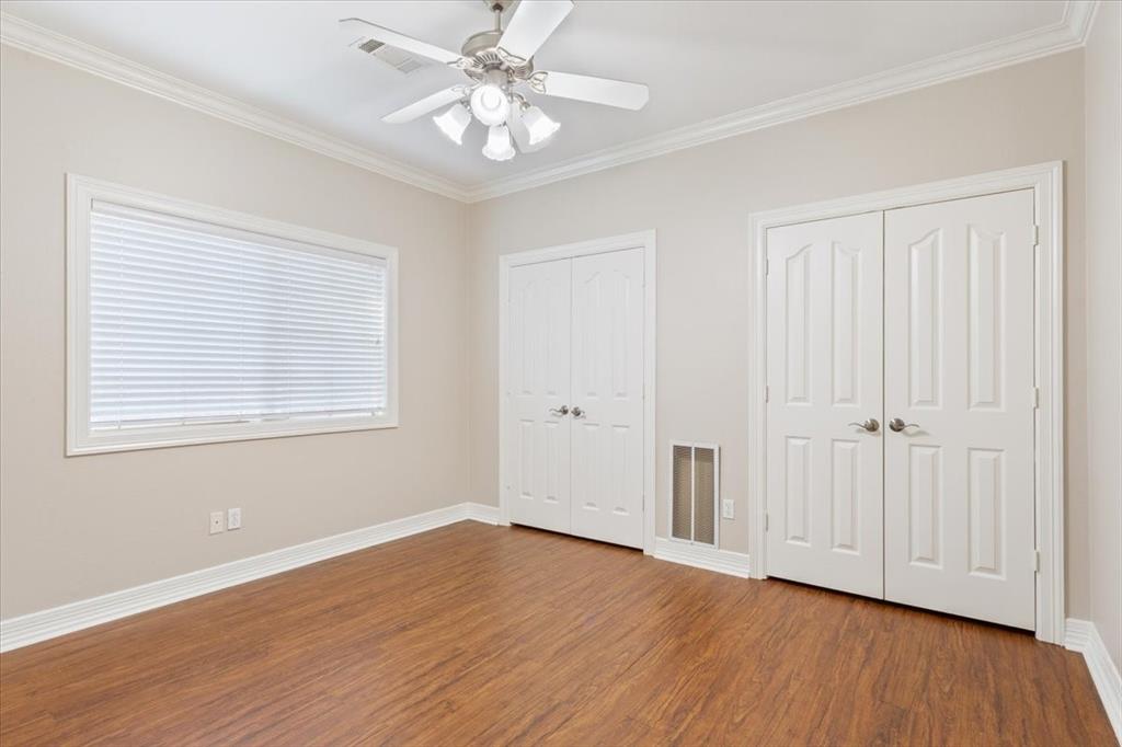 9412 Silverthorn Drive Waco, TX 76708 - Photo 13 of 16 a view of an empty room with wooden floor and a window