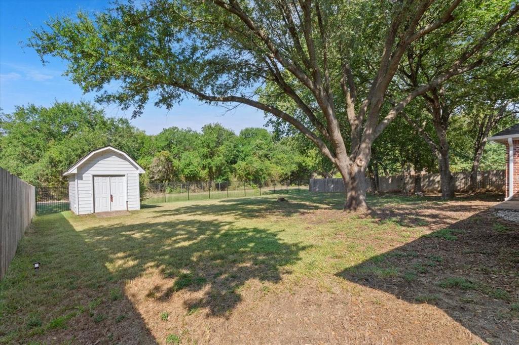 9412 Silverthorn Drive Waco, TX 76708 - Photo 15 of 15 a view of a tree in front of a house with large trees
