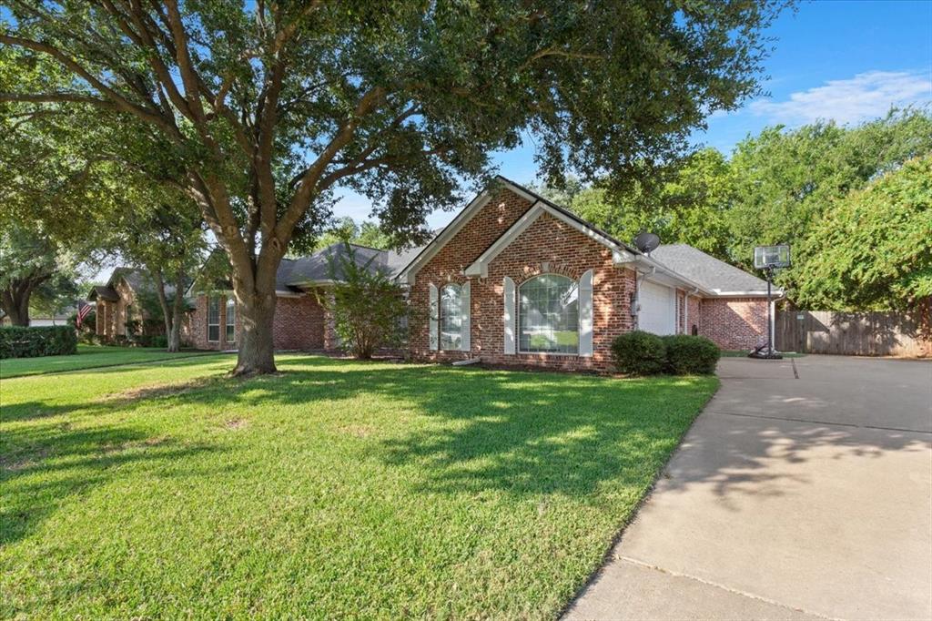 9412 Silverthorn Drive Waco, TX 76708 - Photo 2 of 16 a front view of a house with a yard and trees
