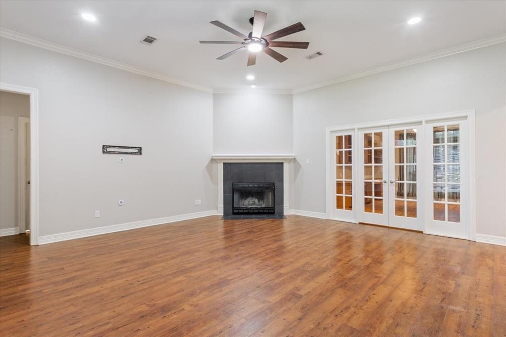 9412 Silverthorn Drive Waco, TX 76708 - Photo 4 of 16 a view of an empty room with a fireplace and a window