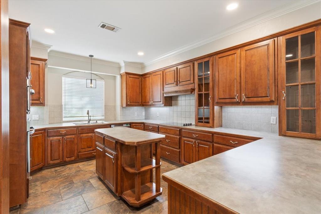 9412 Silverthorn Drive Waco, TX 76708 - Photo 8 of 16 a kitchen with stainless steel appliances granite countertop a sink a stove and a microwave
