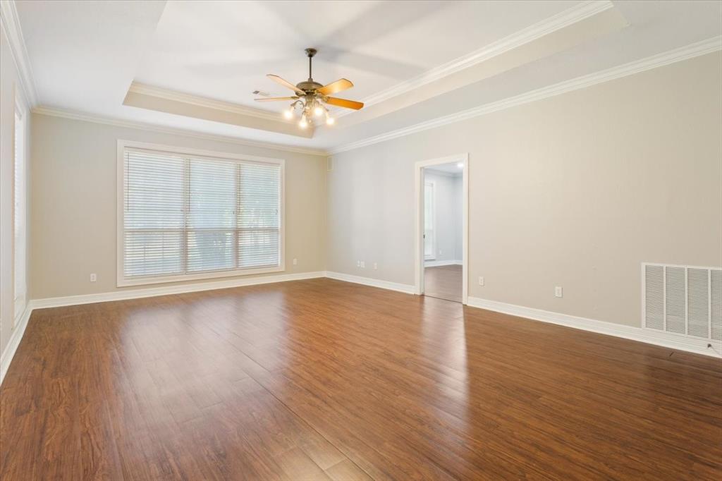 9412 Silverthorn Drive Waco, TX 76708 - Photo 9 of 16 a view of an empty room with wooden floor and a window