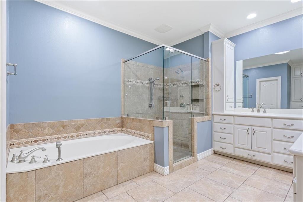 9412 Silverthorn Drive Waco, TX 76708 - Photo 10 of 16 a spacious bathroom with a granite countertop sink a mirror and a bathtub