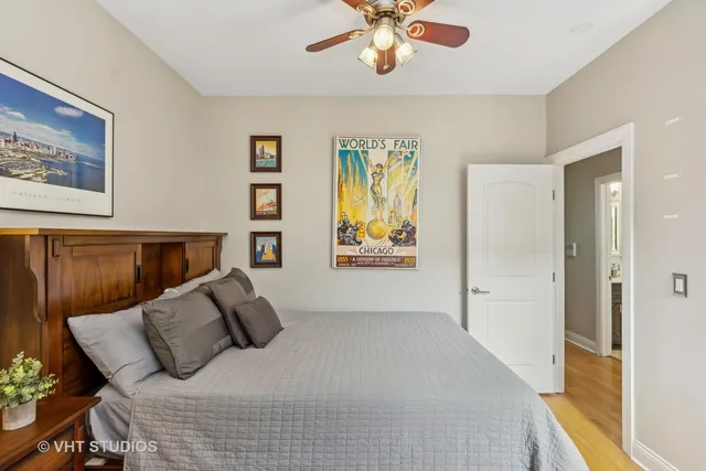 a bedroom with a large bed and a chandelier