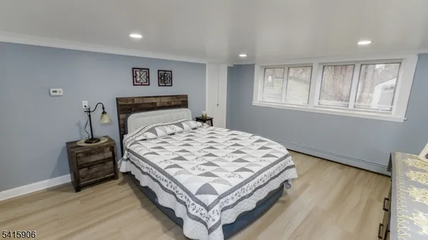 a bed sitting in a spacious bedroom next to a window