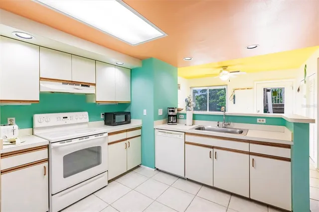 a kitchen that has a sink and a stove in it