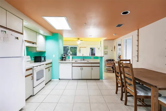 a kitchen with a sink a counter top space cabinets and stainless steel appliances
