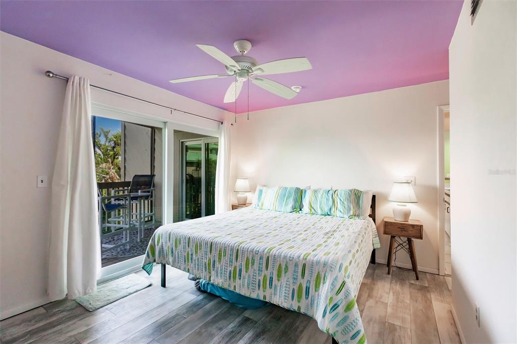 9200 Little Gasparilla, Unit 203 Placida, FL 33946 - Photo 24 of 41 a bedroom with a bed and a mirror