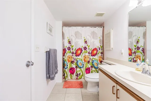 a bathroom with a sink mirror vanity and toilet