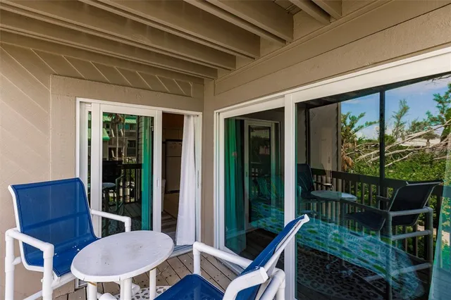 a view of a porch with furniture and wooden floor