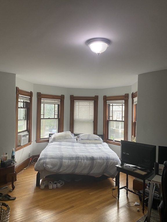 1122 Adams Street, Unit 2 Boston, MA 02124 - Photo 11 of 21 a bedroom with a bed and wooden floor