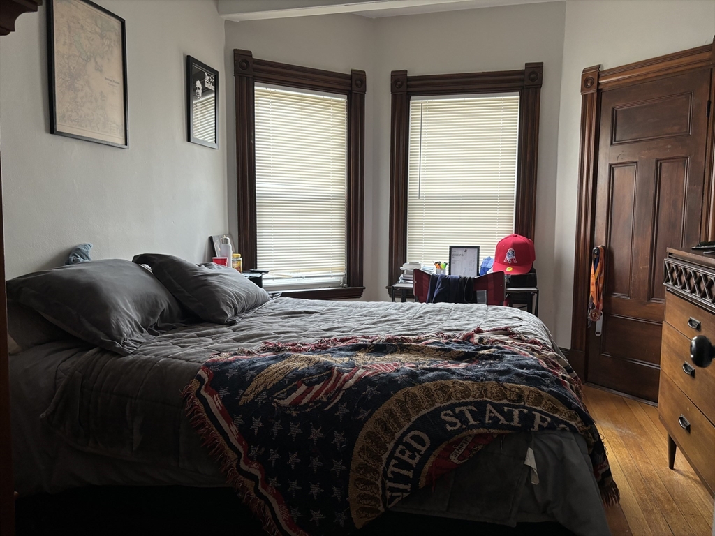 1122 Adams Street, Unit 2 Boston, MA 02124 - Photo 12 of 21 a bedroom with a bed and a window