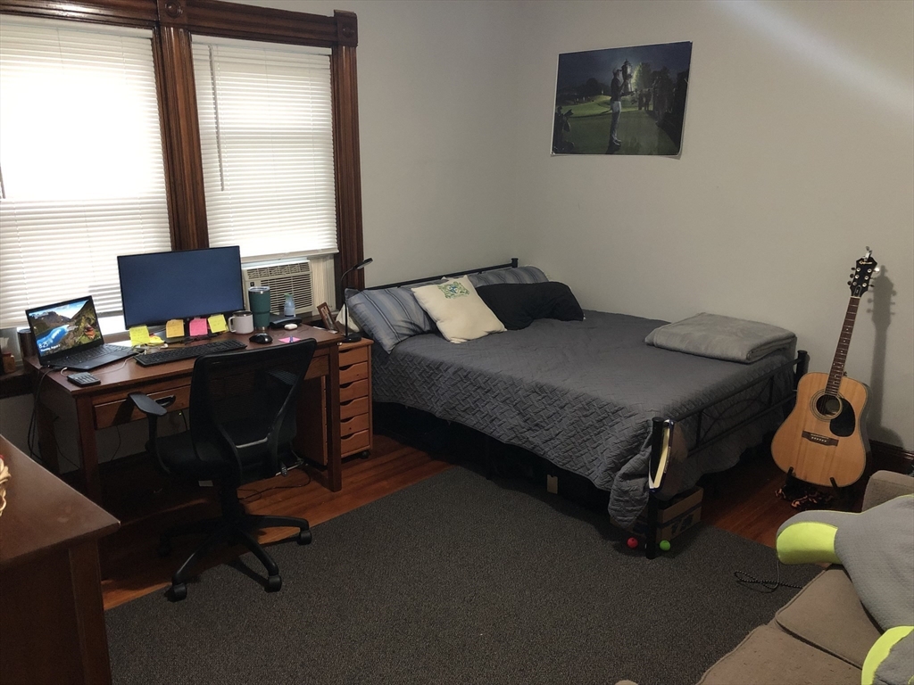 1122 Adams Street, Unit 2 Boston, MA 02124 - Photo 14 of 21 a bedroom with a bed and a window