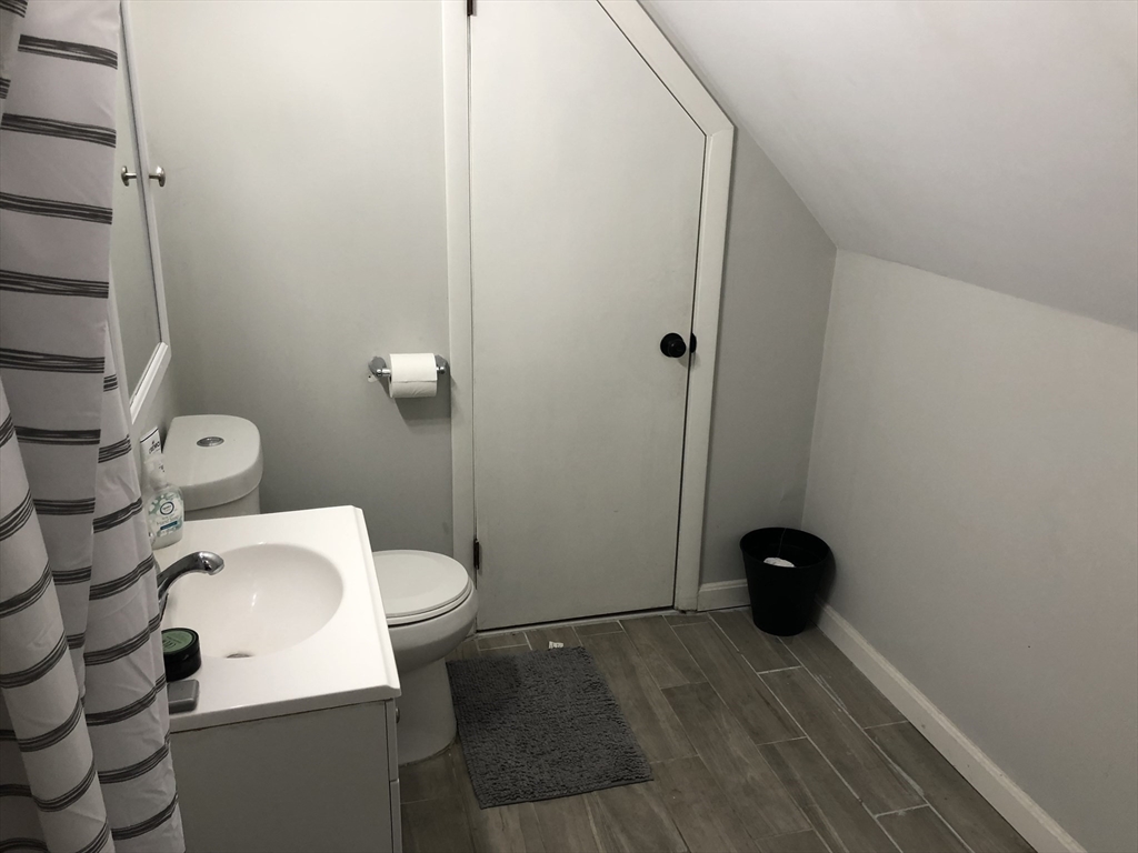 1122 Adams Street, Unit 2 Boston, MA 02124 - Photo 17 of 21 a white toilet sitting next to a bathroom sink