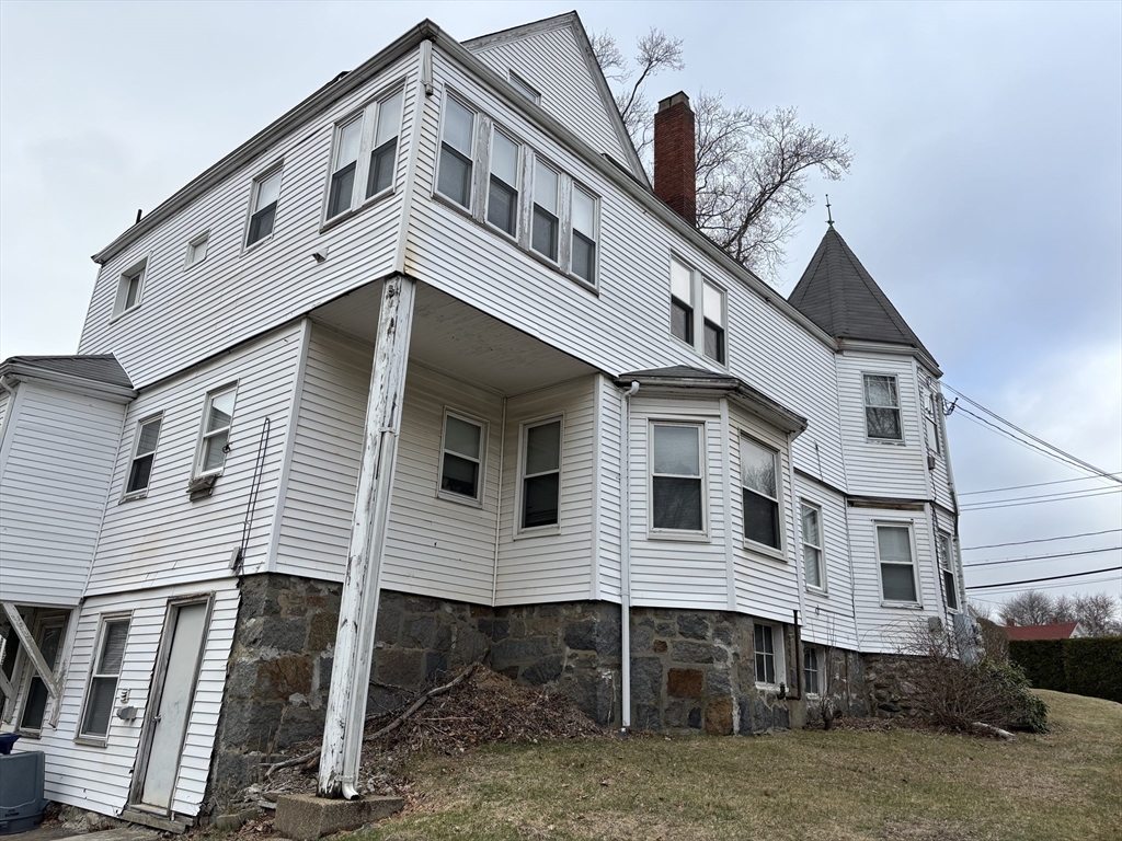 1122 Adams Street, Unit 2 Boston, MA 02124 - Photo 2 of 21 a front view of a house with a balcony