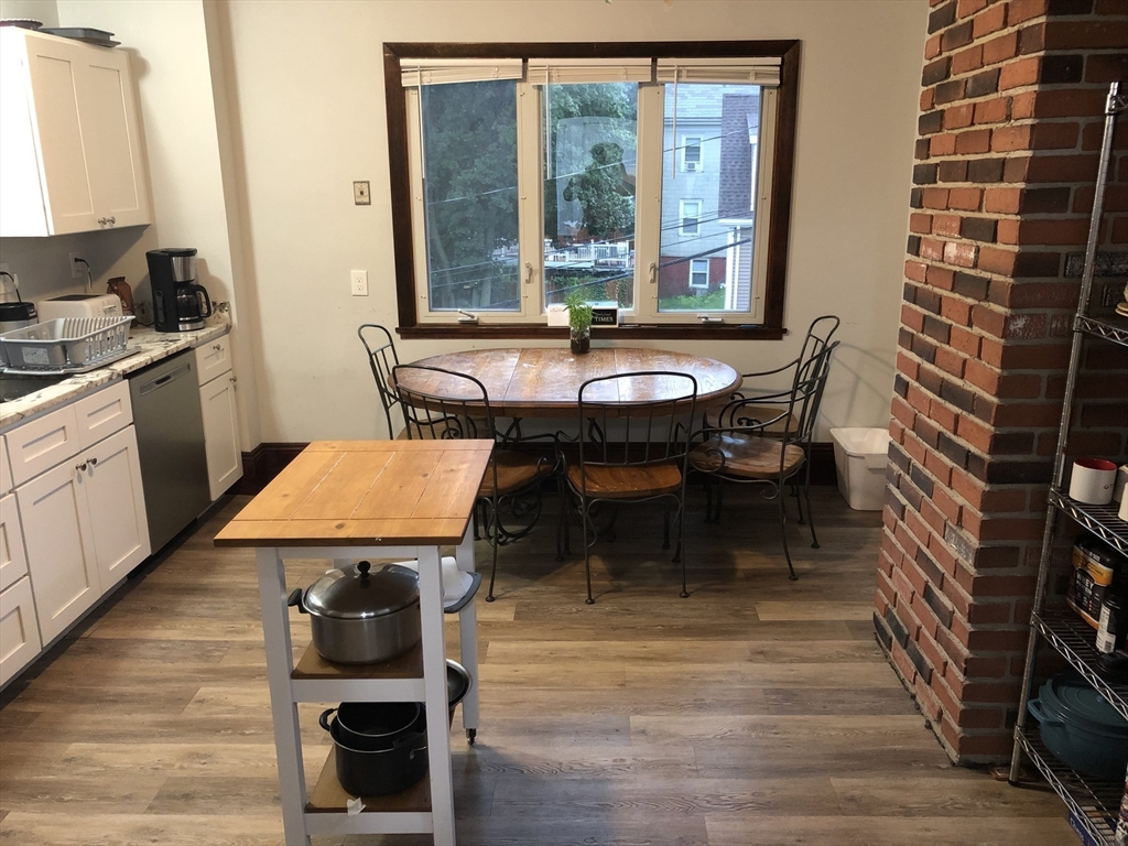 1122 Adams Street, Unit 2 Boston, MA 02124 - Photo 3 of 21 a dining room with furniture and wooden floor
