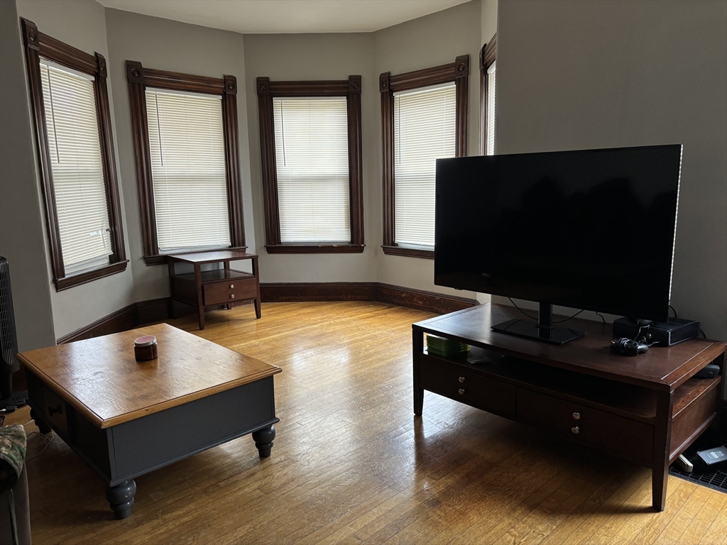 1122 Adams Street, Unit 2 Boston, MA 02124 - Photo 9 of 21 a living room with table flat screen tv and a window
