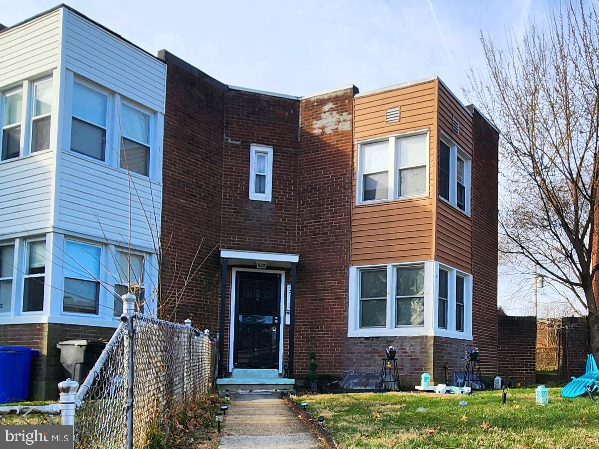 2710 Woodview Road Baltimore, MD 21225 - Photo 1 of 17 a front view of a house with a yard