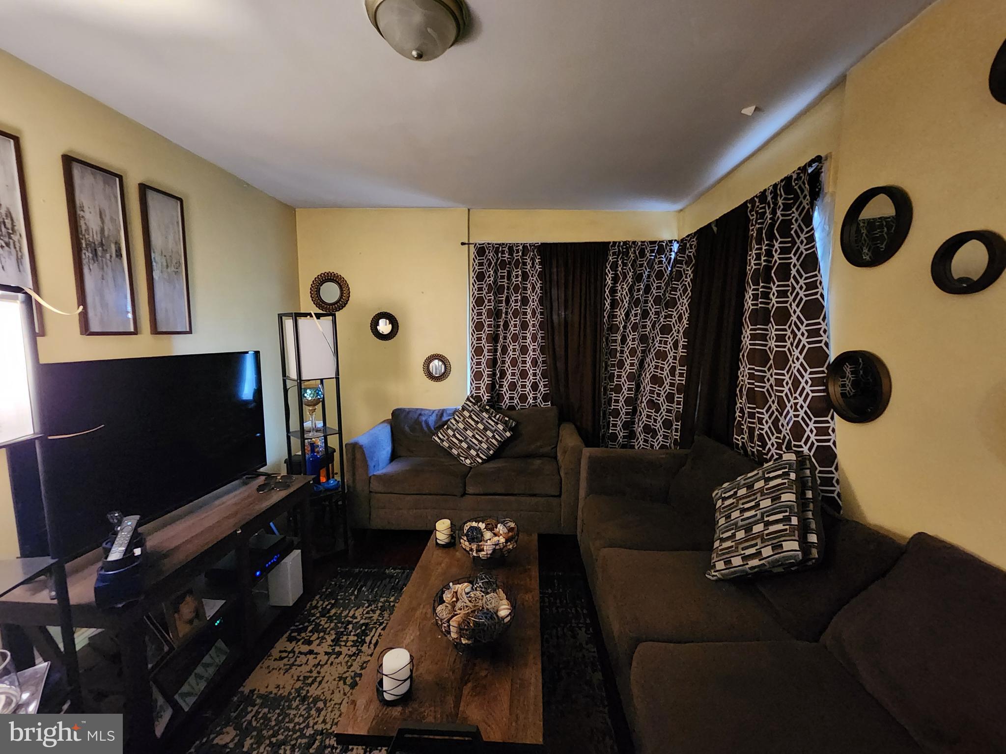2710 Woodview Road Baltimore, MD 21225 - Photo 5 of 17 a living room with furniture and a flat screen tv