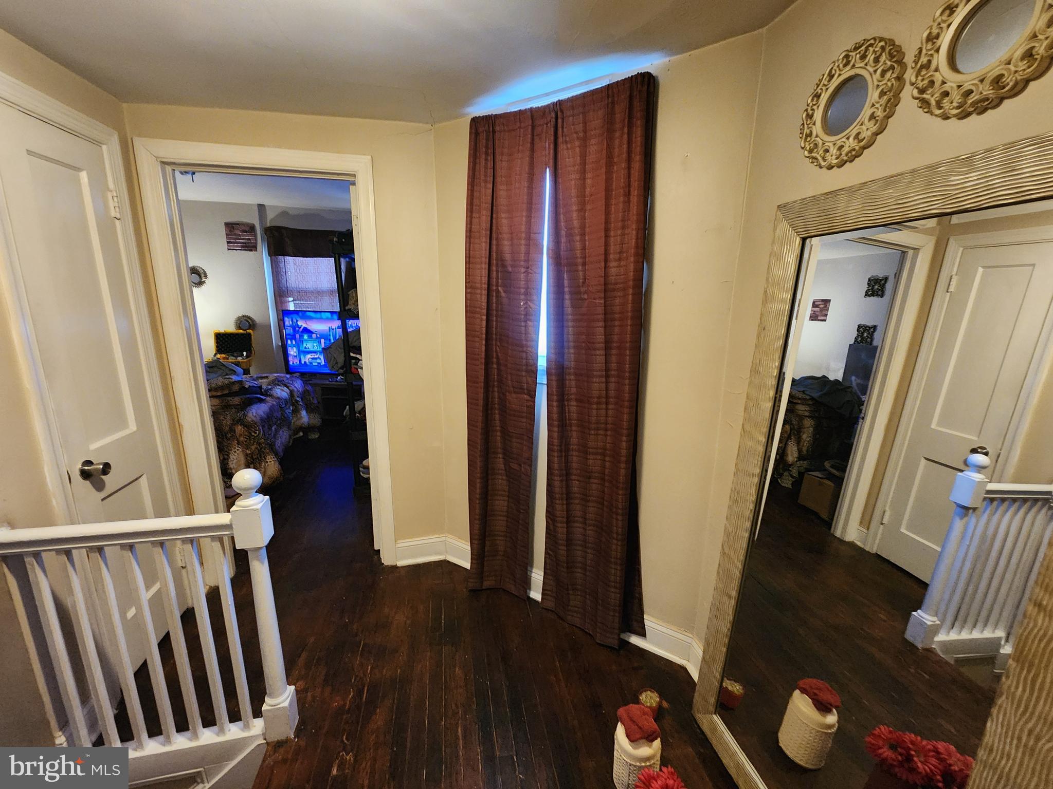 2710 Woodview Road Baltimore, MD 21225 - Photo 8 of 17 a view of a hallway with wooden floor and stairs