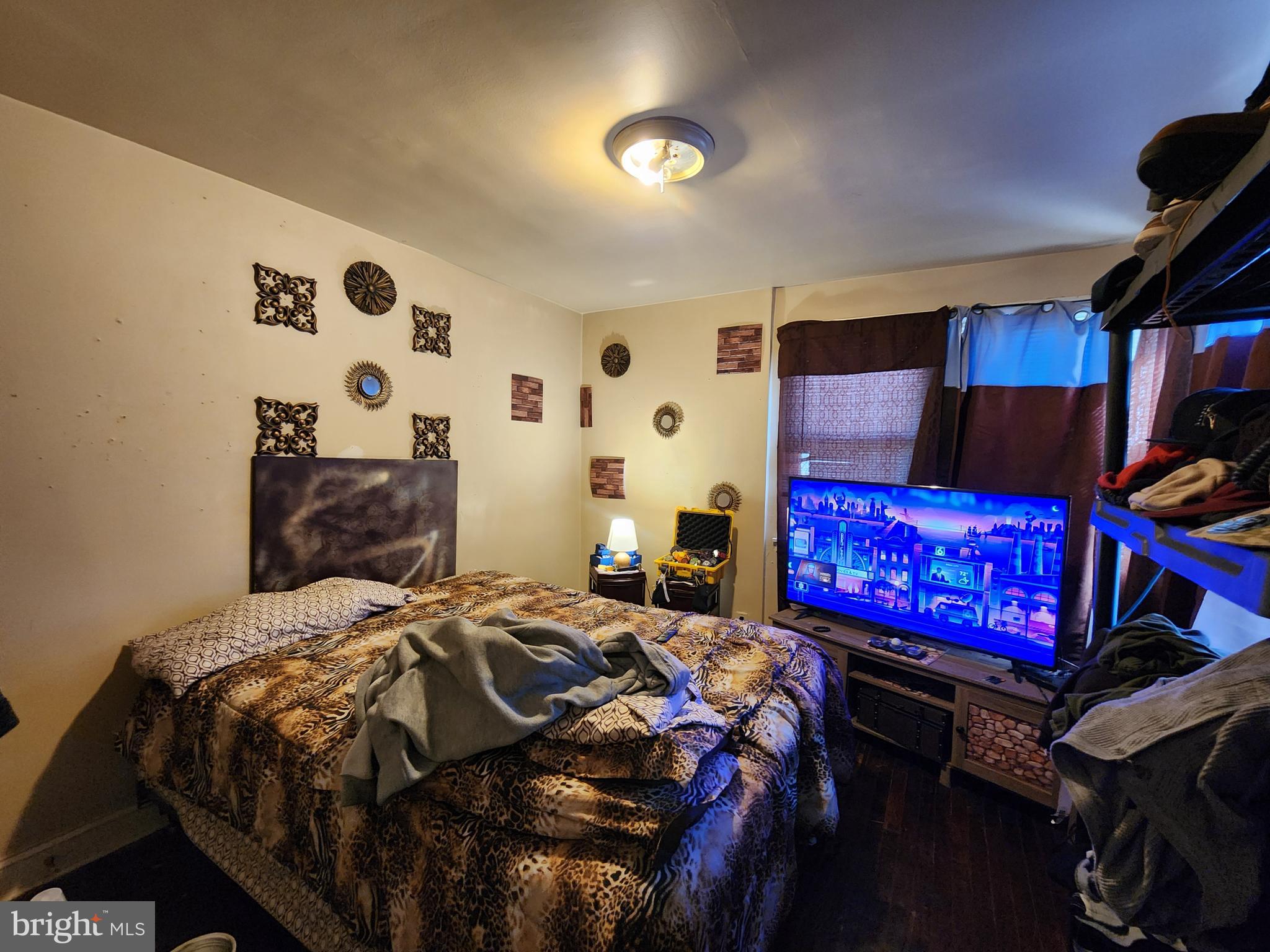 2710 Woodview Road Baltimore, MD 21225 - Photo 9 of 17 a bed sitting in a bedroom next to a lamp