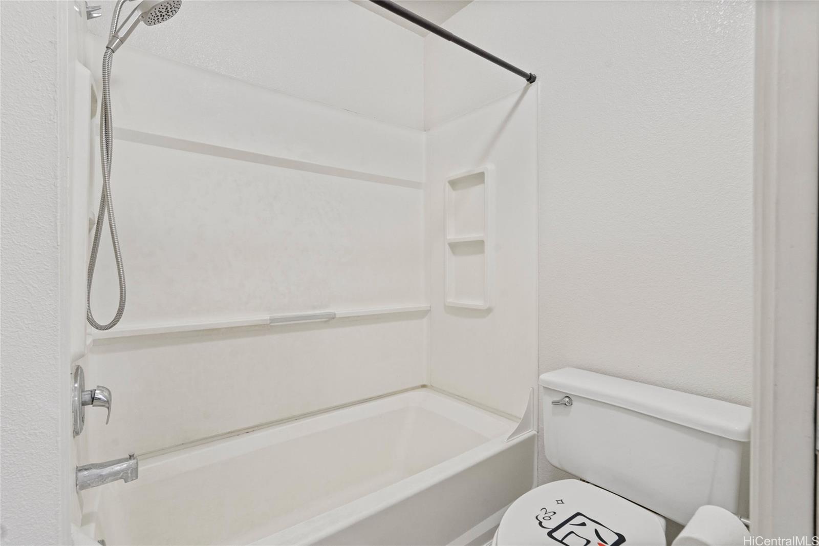 91-299 Hanapouli Circle, Unit 1C Ewa Beach, HI 96706 - Photo 12 of 25 a bathroom with a toilet and a shower