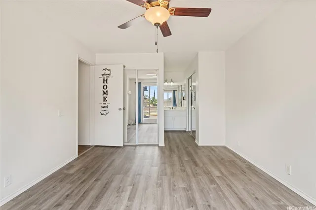 a view of empty room with wooden floor
