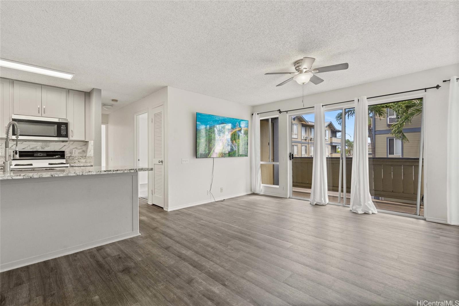 91-299 Hanapouli Circle, Unit 1C Ewa Beach, HI 96706 - Photo 2 of 25 a view of a kitchen with a microwave and a stove