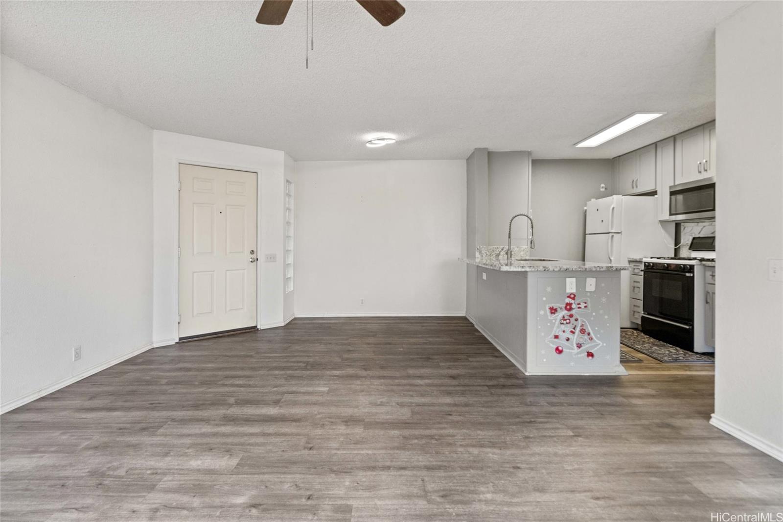 91-299 Hanapouli Circle, Unit 1C Ewa Beach, HI 96706 - Photo 6 of 25 a view of kitchen center island and stainless steel appliances