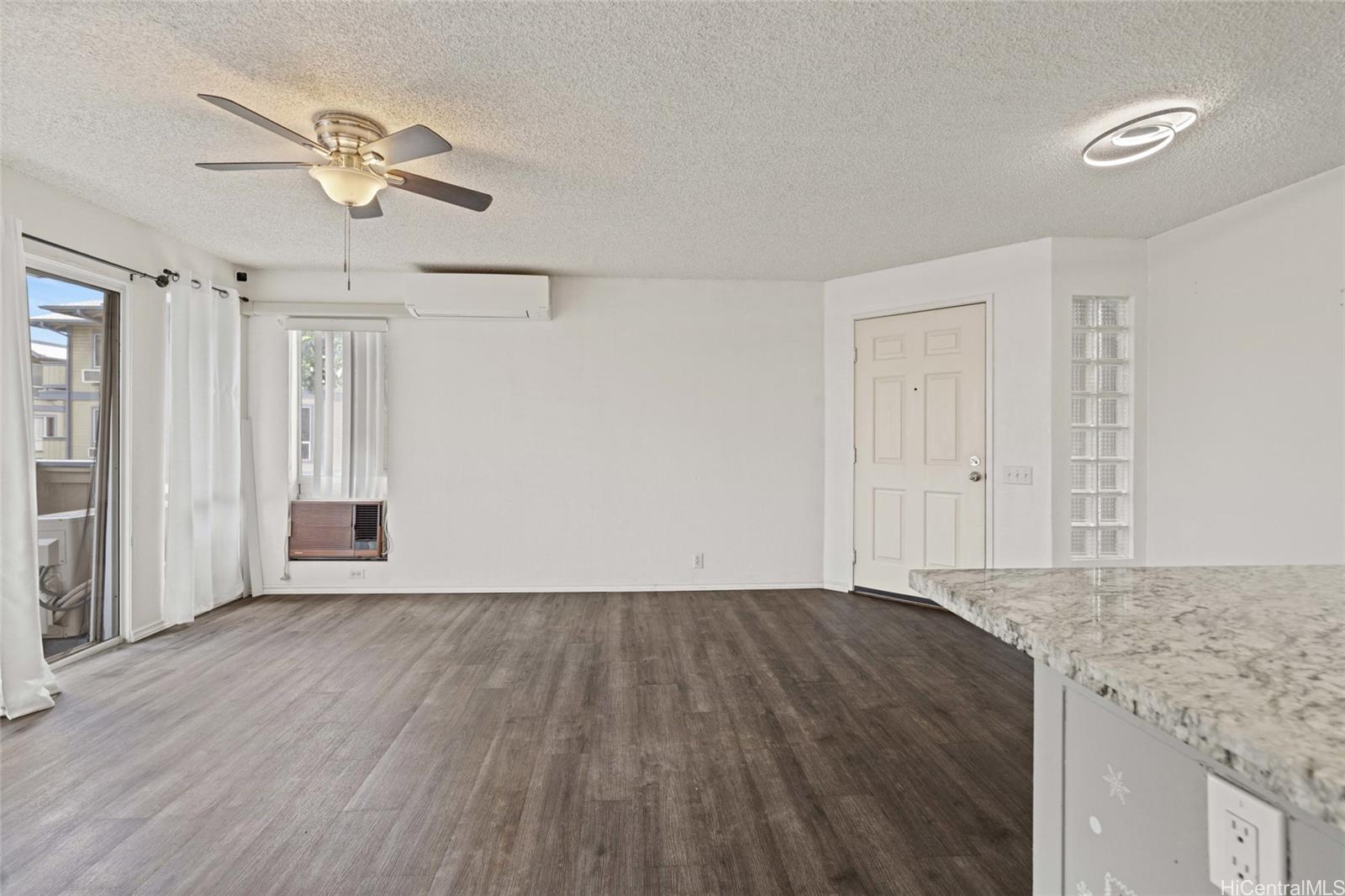 91-299 Hanapouli Circle, Unit 1C Ewa Beach, HI 96706 - Photo 7 of 25 wooden floor in an empty room