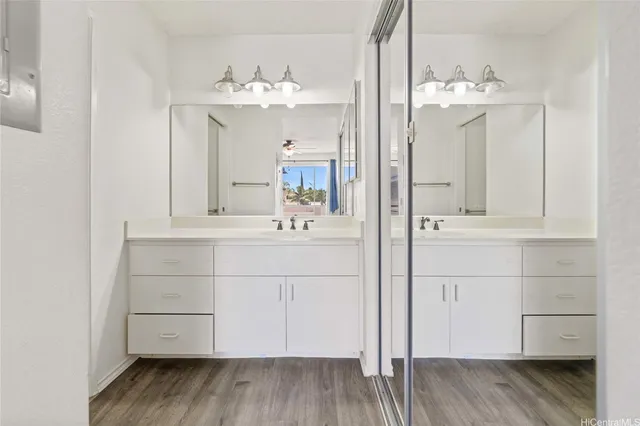 a bathroom with a sink vanity and a mirror